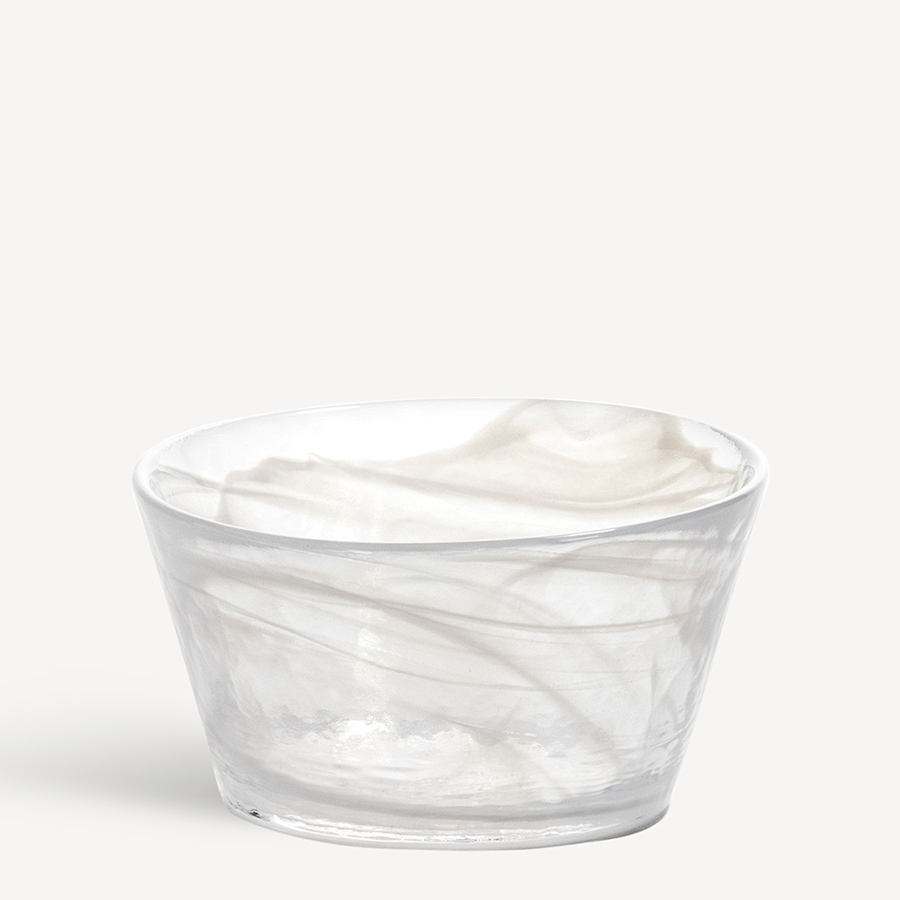 The KostaBoda: Mine White Bowl showcases a clear glass design with a subtle marbled pattern in light shades against a plain background, echoing Ulrica Hydman Valliens artistic flair.