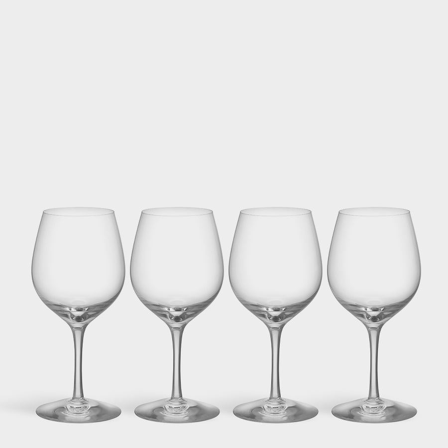 The Orrefors: More Bistro Wine Glass set, designed by Erika Lagerbielke, features four glasses elegantly arranged in a row on a plain white background.