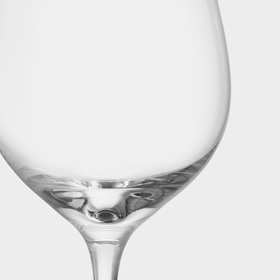 Close-up of an empty, elegant Orrefors: More Bistro Wine Glass (4-Pack), designed by Erika Lagerbielke, against a white background.