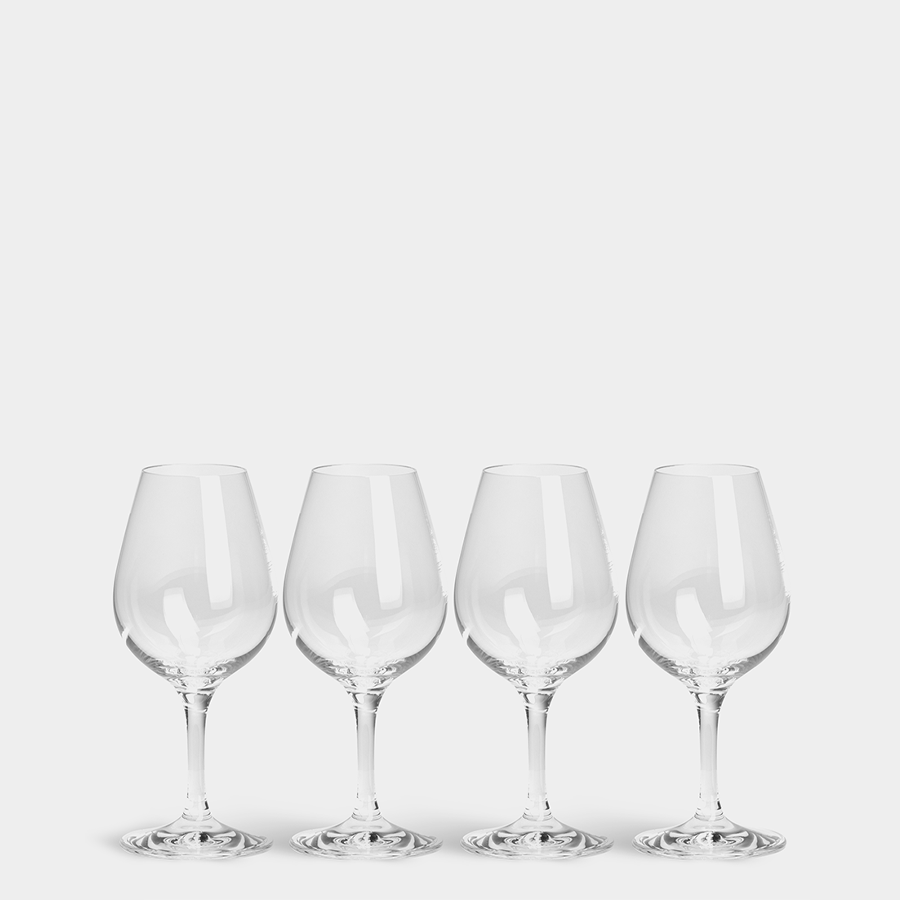 A set of four Orrefors: More Spirits Glass 7oz (4-Pack) wine glasses are lined against a plain background, highlighting their pristine clarity and elegance characteristic of Orrefors craftsmanship.