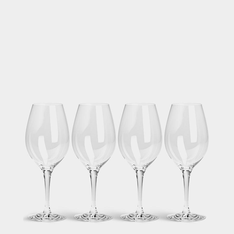 A set of four Orrefors: More Wine Glasses, designed by Erika Lagerbielke, is elegantly displayed against a pristine white background.