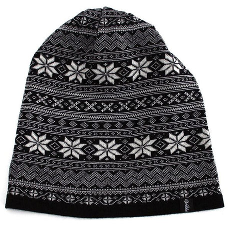 The Northern Story Setesdal Hat is a black and white 100% Merino wool beanie featuring a Nordic-inspired snowflake and geometric design, reminiscent of the classic Selbu star Norwegian pattern.