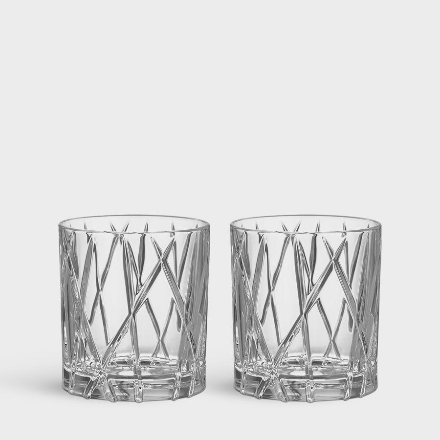 The Orrefors City Old Fashioned Glass 8oz 2-Pack features clear faceted tumblers with crisscross designs, embodying a stylish nod to the city old-fashioned aesthetic.