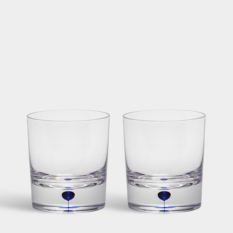 Two Orrefors: Intermezzo Blue Old Fashioned Whiskey 8.5oz glasses with a blue dot design near the base are placed side by side on a plain background.