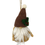 Hand-felted tomte gnome ornament with a brown hat, white beard, and holly accent, hanging by a string against a white background.