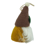 Side view of a hand-felted tomte ornament with a brown hat, yellow body, white beard, green patch on the side, and attached string loop for hanging.