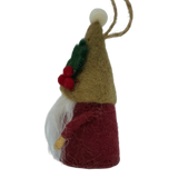 Hand-felted tomte gnome ornament with a tall brown hat, red berries, green leaves, white beard, red body, and a string loop for hanging.