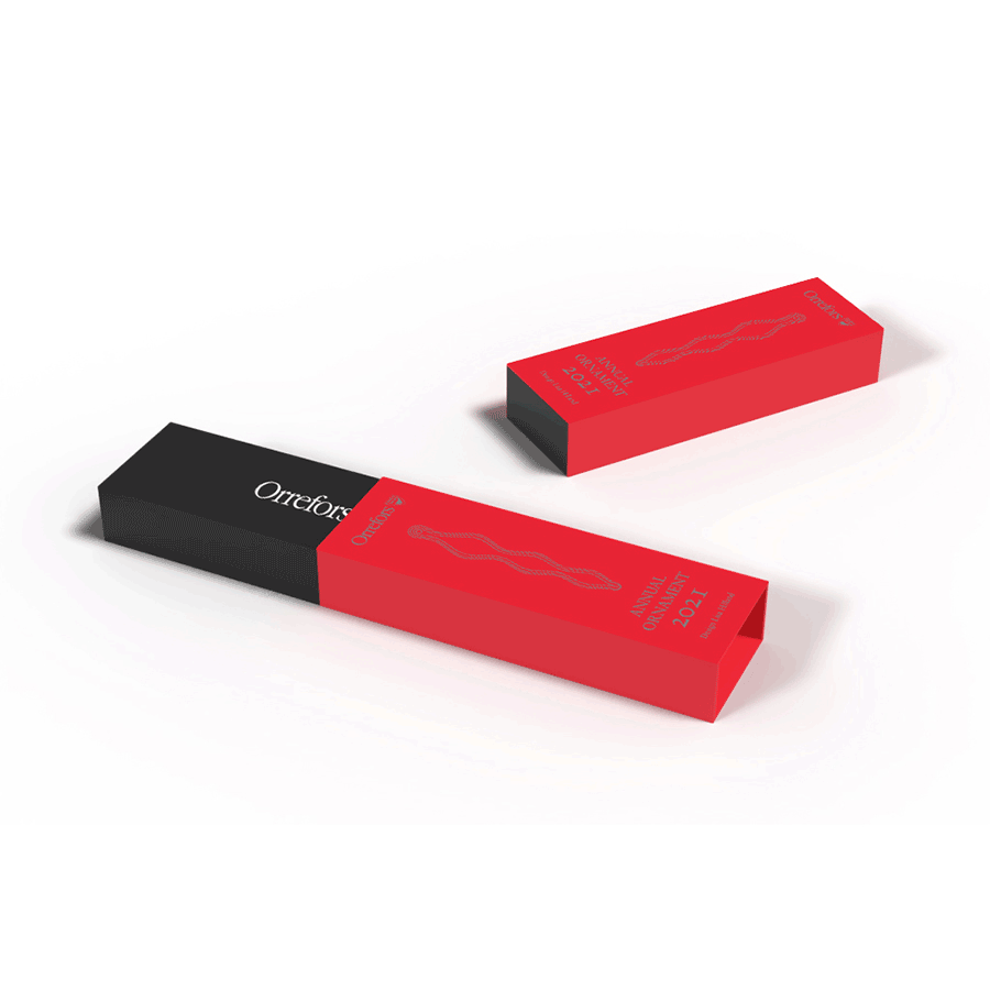 Two Orrefors products in rectangular boxes with a black and red design feature a wavy line graphic and the word Orotic, reminiscent of classic Orrefors Designs.