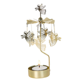 Rotary candle holder with gold flying angels above a lit tealight, metallic blades at the top, and a Scandinavian design.