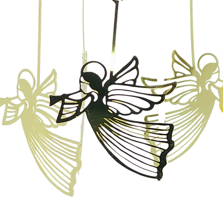 Four gold Scandinavian-style angel ornaments with wings and trumpets hang suspended; one appears darker in front, while three lighter ones are blurred in the background.