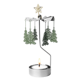 Metal rotary candle holder carousel with Christmas tree-shaped ornaments and a star topper, spinning above a lit tealight candle, on a white background.