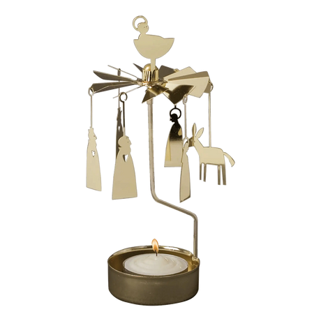 Gold-tone metal Swedish candle carousel featuring hanging Nativity figures, a star topper, and a burning tea light in the base.