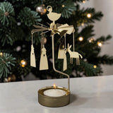 Gold-tone metal Swedish angel chimes with hanging donkey and angel figures and a lit tea light candle at the base.
