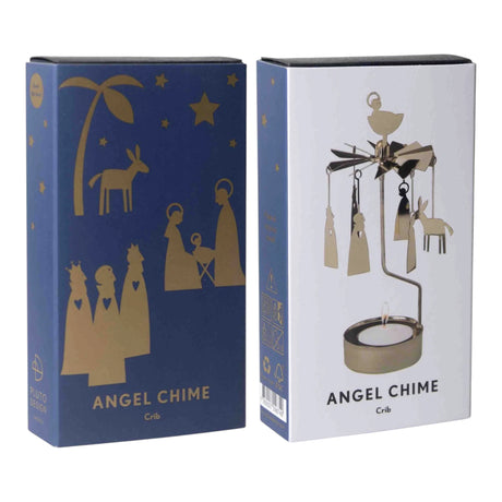 A metal Scandinavian angel chime with a nativity scene, displayed next to its blue and white product packaging.