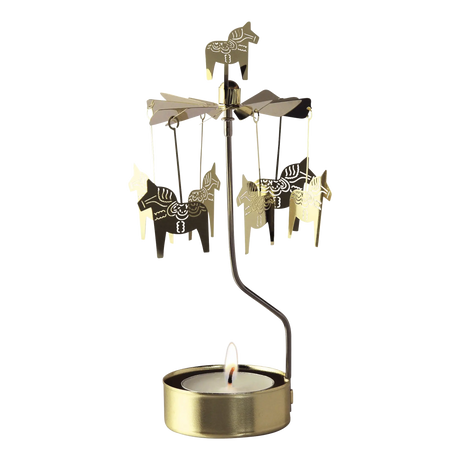Gold Swedish rotary candle holder with Dala horse silhouettes and a lit tea light.