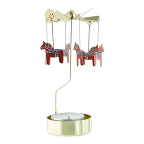 Gold-toned metal Swedish rotary candle holder with hanging red Dala horses featuring blue and white rosemaling patterns.