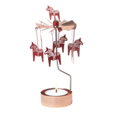 Rose gold Dala Horse metal figures spin on a rotary candle holder above a tealight in a copper holder, shown against a plain white background.