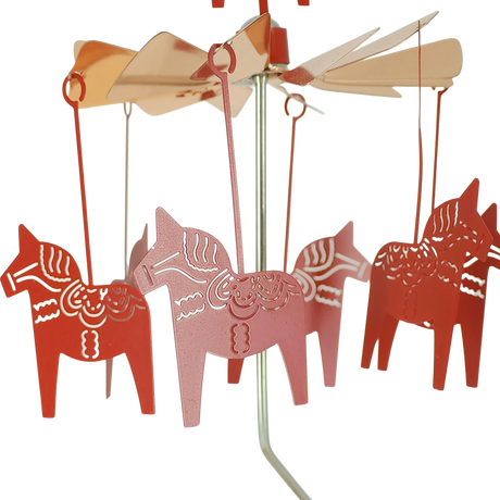 Rose gold Dala horse figures suspended from a circular metal mobile with a central pole, arranged evenly in a Scandinavian-inspired design.