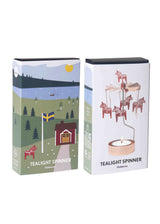 Rotary candle holder in rose gold with Swedish Dala horse charms and countryside motifs. Metal spinner at the top. Candle base is empty; no candle included.