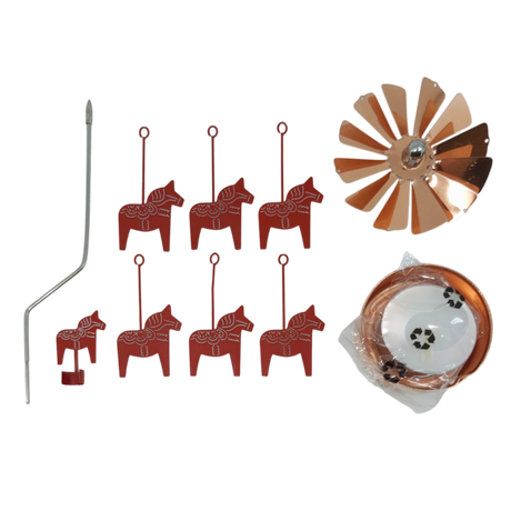 Six red Dala horse ornaments, a bent metal rod, a copper wind spinner, and a coiled copper strip arranged on a white surface.