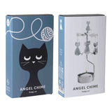 Two rotary candle holder boxes: one blue with a cat graphic and one white showing the metal spinning ornament with a lit candle.