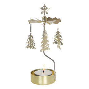 Gold rotary candle holder with star-topped Christmas tree-shaped ornaments spinning above a lit tealight. Plain white background.