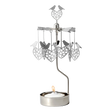 Rotary candle holder with love bird and heart shapes suspended above a lit tealight, all crafted from silver-toned recycled metal.