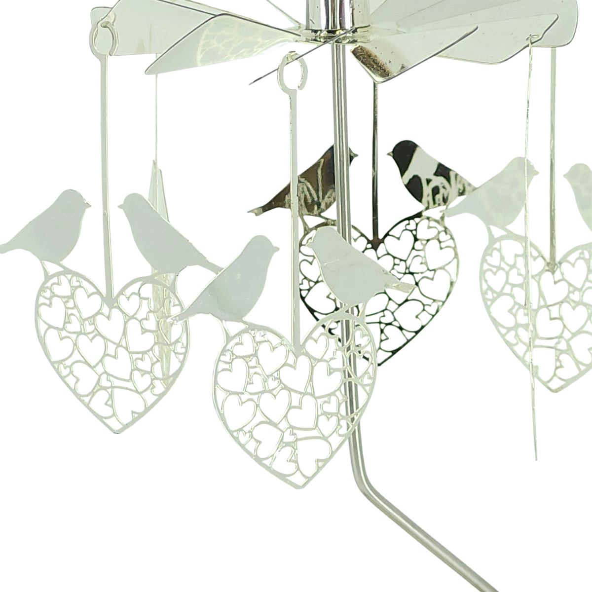 Rotary candle holder with silver finish, featuring intricate cutouts and hanging ornaments shaped like love birds and hearts.