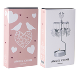 Two pink and white boxes labeled “Angel Chime Bird Heart” with love bird and heart graphics; one box displays a rotary candle holder assembled above a tealight.
