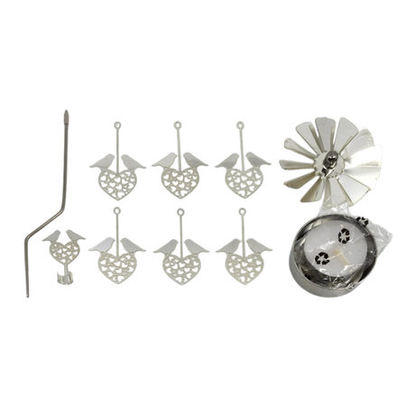 Silver rotary candle holder with six heart-shaped ornaments featuring love birds, a bent metal rod, clamp, fan-like spinner, and a round base made of recycled metal.