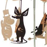 Metal cutouts featuring a top-hatted Moomin character and a black dog-like figure hanging from a reflective rod.