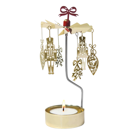 Gold-colored Swedish rotary candle holder featuring hanging nutcracker and ornament silhouettes, topped with a red bow.