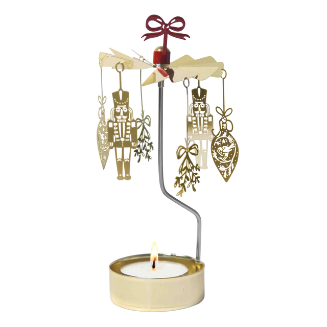 Gold-colored Swedish rotary candle holder featuring hanging nutcracker and ornament silhouettes, topped with a red bow.