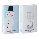 Packaging for a rotary candle holder showing a snowman illustration on the front and a photograph of the assembled metal spinner on the side.