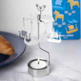 Metal rotary candle holder with hanging Viking ship ornaments.