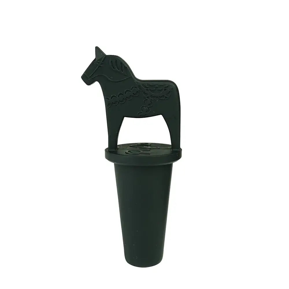 The Vinkork Dala Horse Bottle Stopper features a black stopper with a horse-shaped handle, inspired by the Swedish Dala horse, and has a flat base with decorative details to elegantly enhance your wine collection.