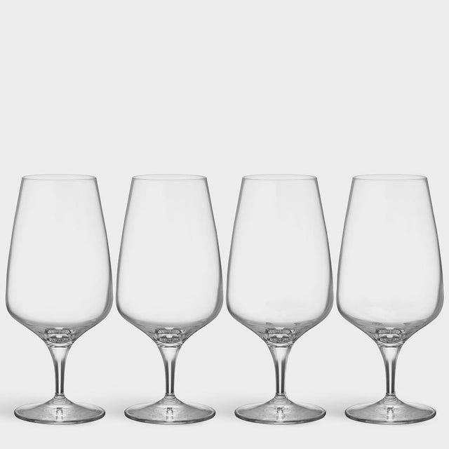Four clear Orrefors Pulse Beer Glasses (18.5oz, 4-pack), designed by Ingegerd Raman, showcase Scandinavian simplicity as they stand in a row against a plain white background.