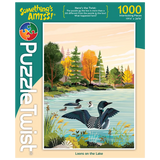 1000-piece puzzle showing Minnesota loons swimming on a lake beneath pale clouds, with trees in fall colors. Artwork by Tim Chapman visible on the box.