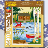 500-piece jigsaw puzzle showing a lakeside cabin, canoe by the shore, wooden dock, two loons on the water, and a woodpecker in the trees.
