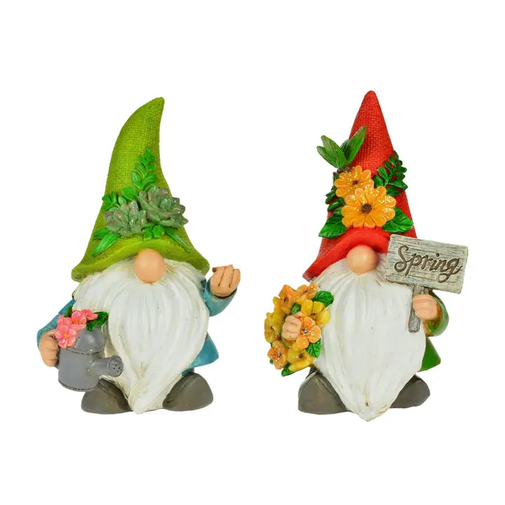 Enhance your gardens charm with two white-bearded gnomes: one in a green hat with a watering can, and the 8 GNOME with Red Hat, carrying a floral Spring sign—an ideal spring decoration.