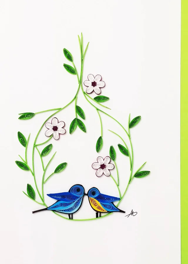 The Cards: Love Birds Quilling Card 5x7 features two blue birds on a branch with green leaves and white flowers, set on a white background—a beautifully handmade card ideal for any occasion.