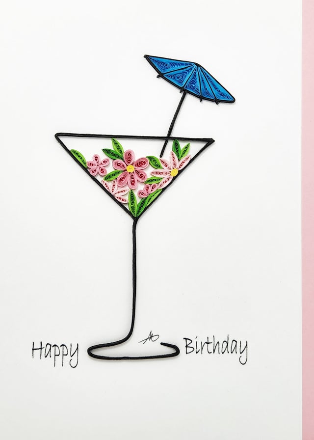 A 5x7 quilling card featuring a hand-crafted martini glass with floral designs, a blue umbrella, and the text "Happy Birthday.