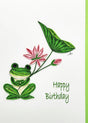 The Frog with Lotus Happy Birthday Quilling Card (5x7) features a green frog holding a leaf and pink flower among lotus blooms on a white background.