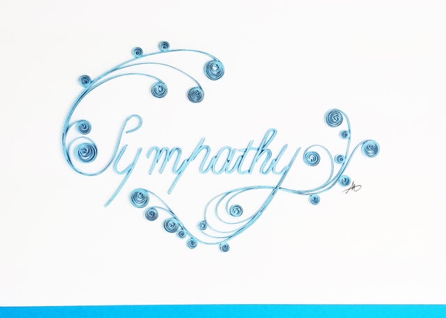 The "Sympathy Quilling Card" features the word Sympathy beautifully crafted in blue with decorative swirls on premium paper, offering an elegant presentation against a white backdrop.