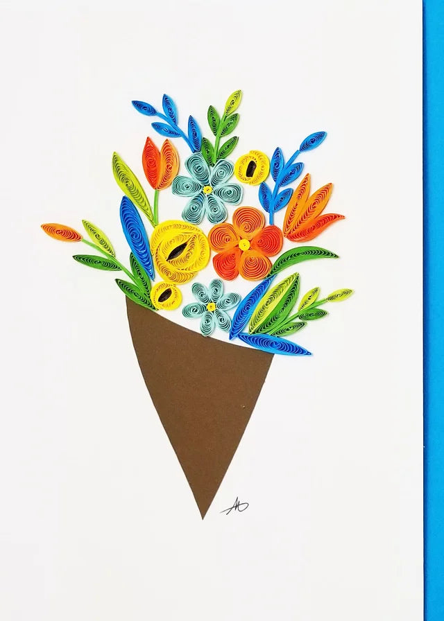 The "Cards: Flower Bouquet Quilling Card" features quilling art of a vibrant floral arrangement with colorful flowers and leaves in a brown paper cone, set against a white background, making it an intricate and unique gift option.