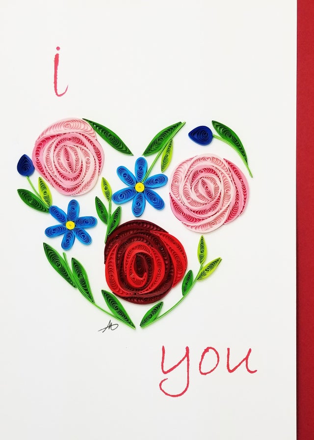 The "Cards: I Heart You Quilling Card" showcases a heart meticulously crafted from intricate quilled flowers and leaves, with the words "I" and "You" gracefully inscribed in red, conveying a deeply heartfelt message.