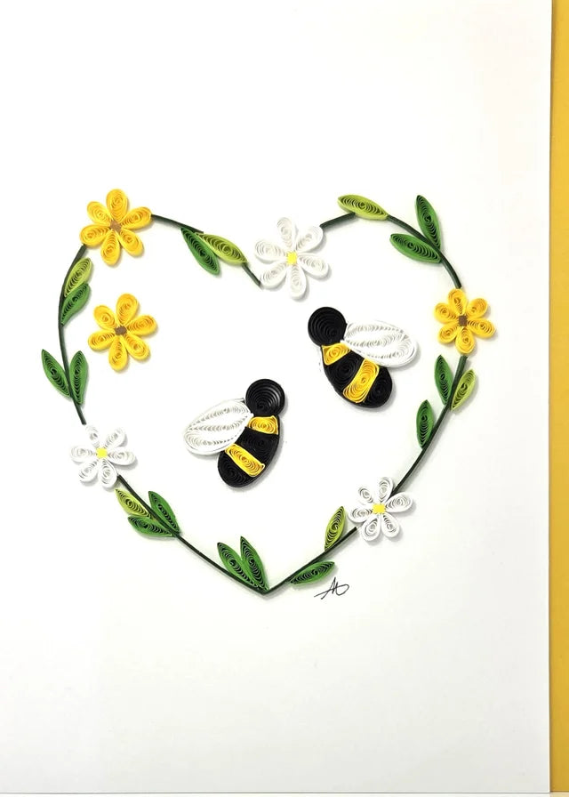 The Bees with Daisy Flowers Heart Quilling Card 5x7 features two bees inside a heart of green leaves and yellow-white flowers—an ideal handmade card for any special occasion.