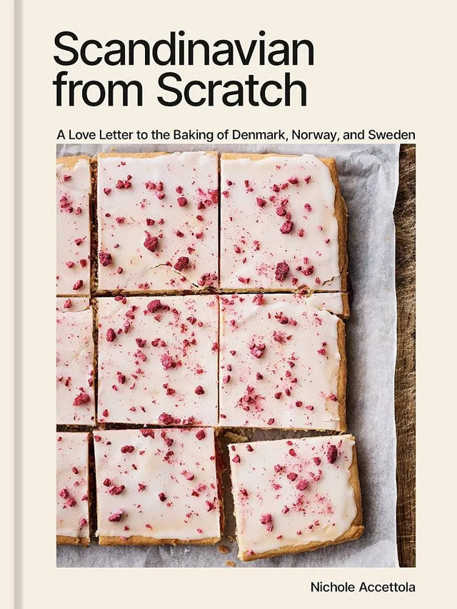 Cookbook with the title “Scandinavian from Scratch” and a cover image of Danish pastries and iced treats topped with pink sprinkles, cut into squares on parchment paper.