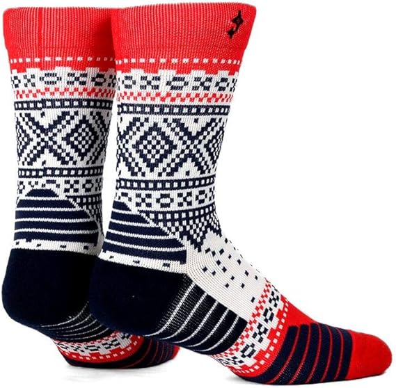 Two socks featuring the Marius Nvrlnd geometric Norwegian pattern in red, white, and navy colors.