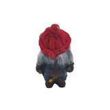 The Nisse Man figurine features a red knit hat, gray hair, and a blue outfit as seen from the back, complete with its signature hammer.
